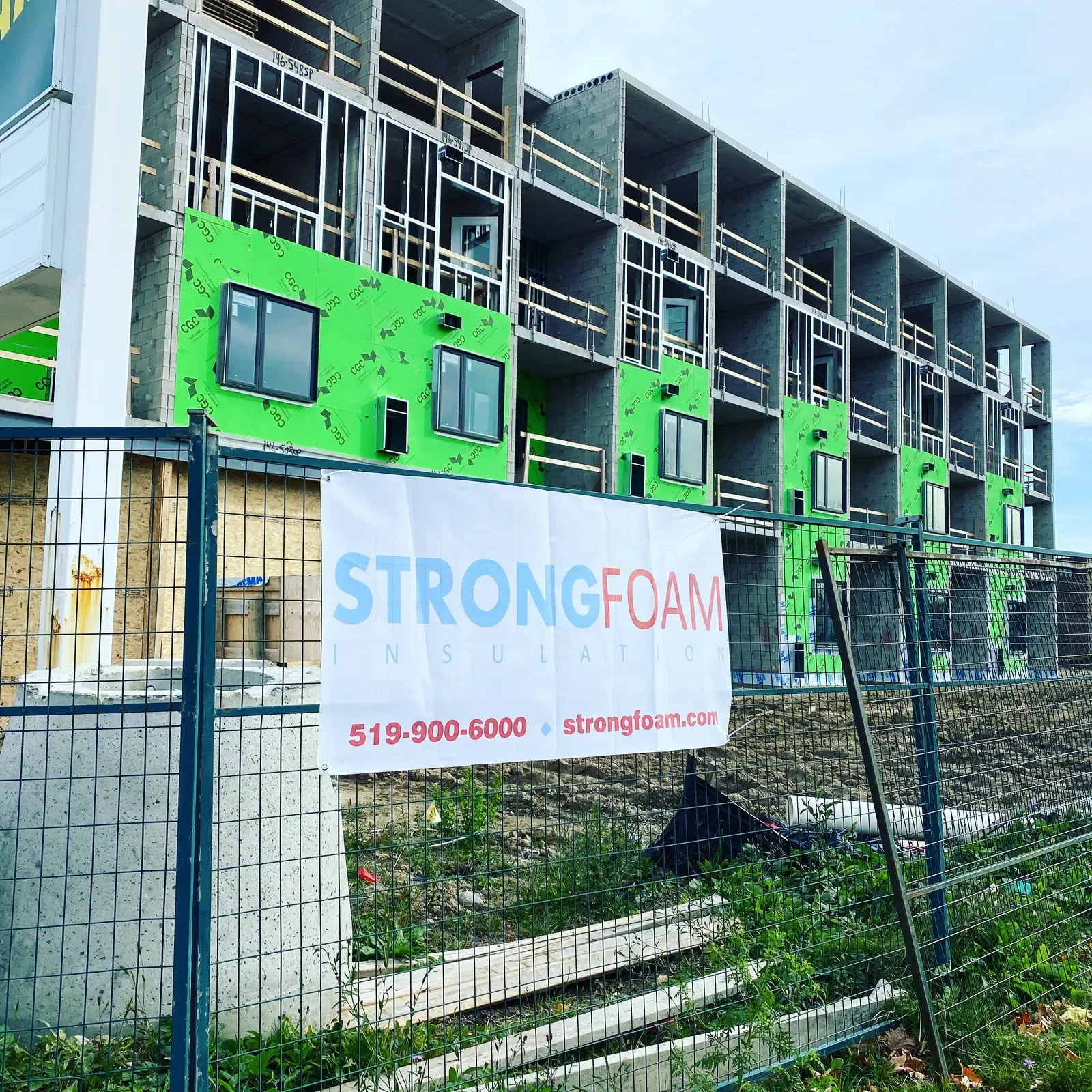 Strong Foam crew and truck at a multi-storey jobsite with air barrier membrane installed