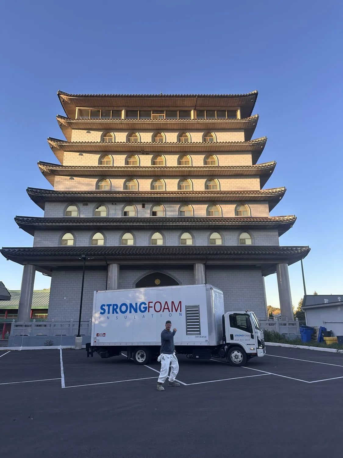 Strong Foam truck and crew member in front of a pagoda-style building